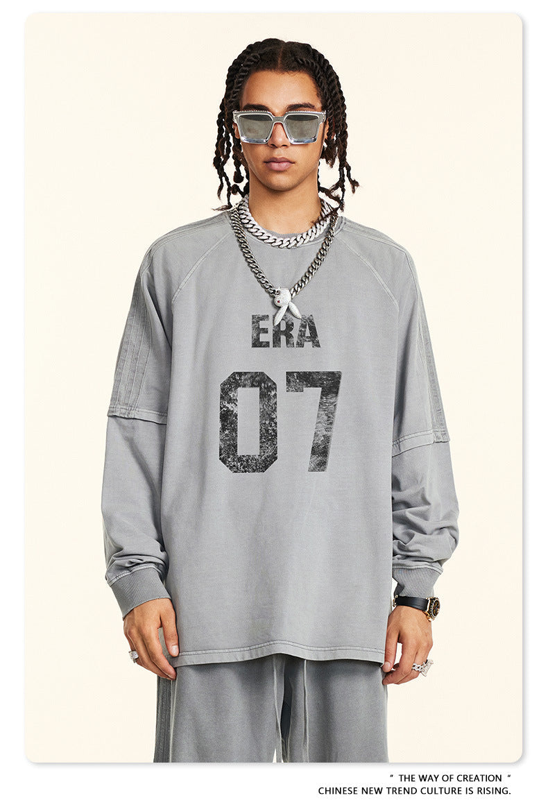 Front view of gray sweatshirt with 'ERA 07' distressed print, worn with matching pants and silver accessories