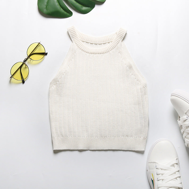 White ribbed halter crop top flatlay with sneakers and yellow-tinted sunglasses