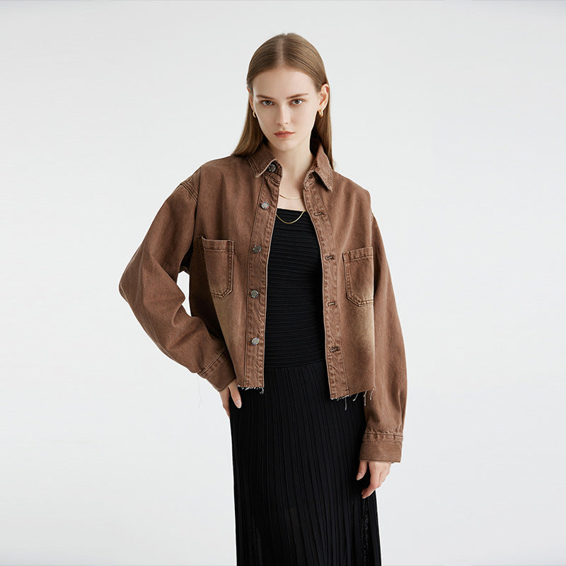 Brown cropped denim jacket with frayed hem, model wearing black ribbed dress, minimalist styling