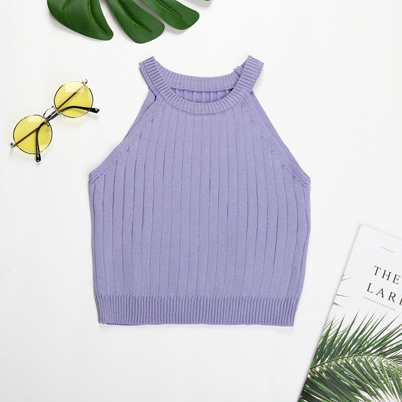 Purple ribbed halter crop top flatlay with monstera leaf and minimal styling