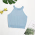 Sky blue ribbed halter crop top flatlay with monstera leaf and minimal styling