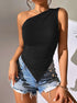 Black one-shoulder bodysuit with ruched detailing and asymmetric hem, paired with distressed denim shorts and gold chain accessories