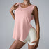 A woman is wearing a blush pink sleeveless tank with rounded hem, paired with ivory shorts, posing with hand on shoulder
