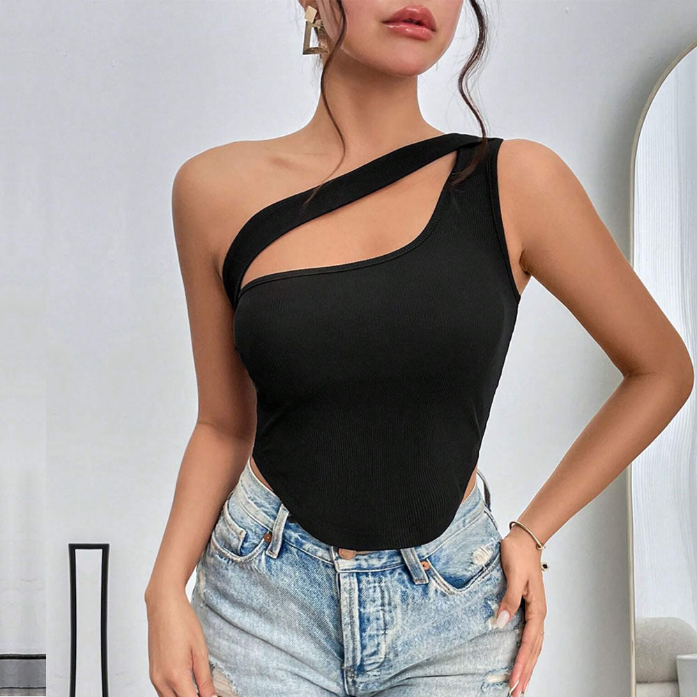 Black one-shoulder top with cutout design, styled with light-wash denim shorts against white background