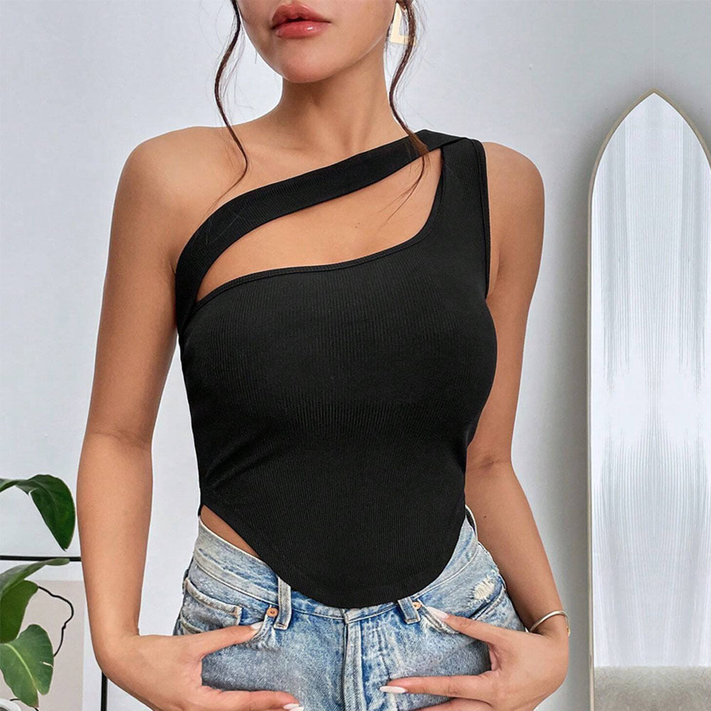 One-shoulder black top with strategic cutout, paired with distressed denim shorts