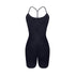 Back view of black performance bodysuit with T-strap design and ruched rear detail on white background