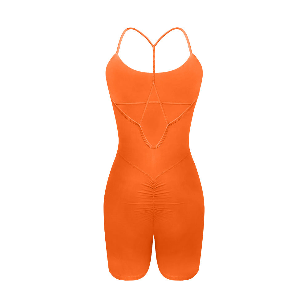 Back view of orange athletic bodysuit showing T-strap design and seamless construction on white background
