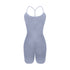 Light gray sleek bodysuit with T-strap back design and built-in compression shorts displayed on white background