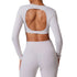 Back view of white long sleeve crop top with large open cutout and high-waisted leggings