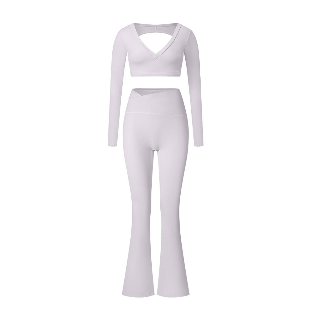 White V-neck long sleeve workout set with crop top and high-waisted leggings against gray background