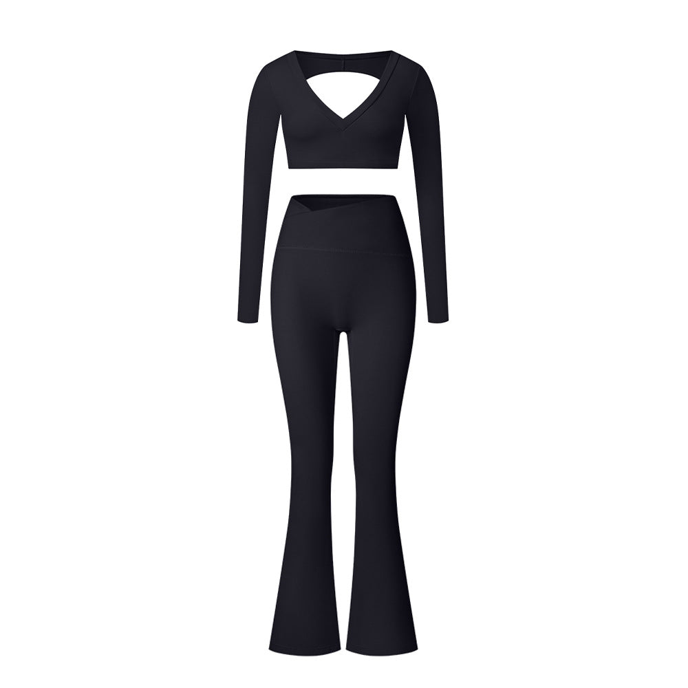 Black V-neck long sleeve workout two-piece with cutout detail and flared leggings on white background