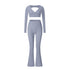 Blue-gray V-neck long sleeve workout set with crop top and flared leg pants on white background