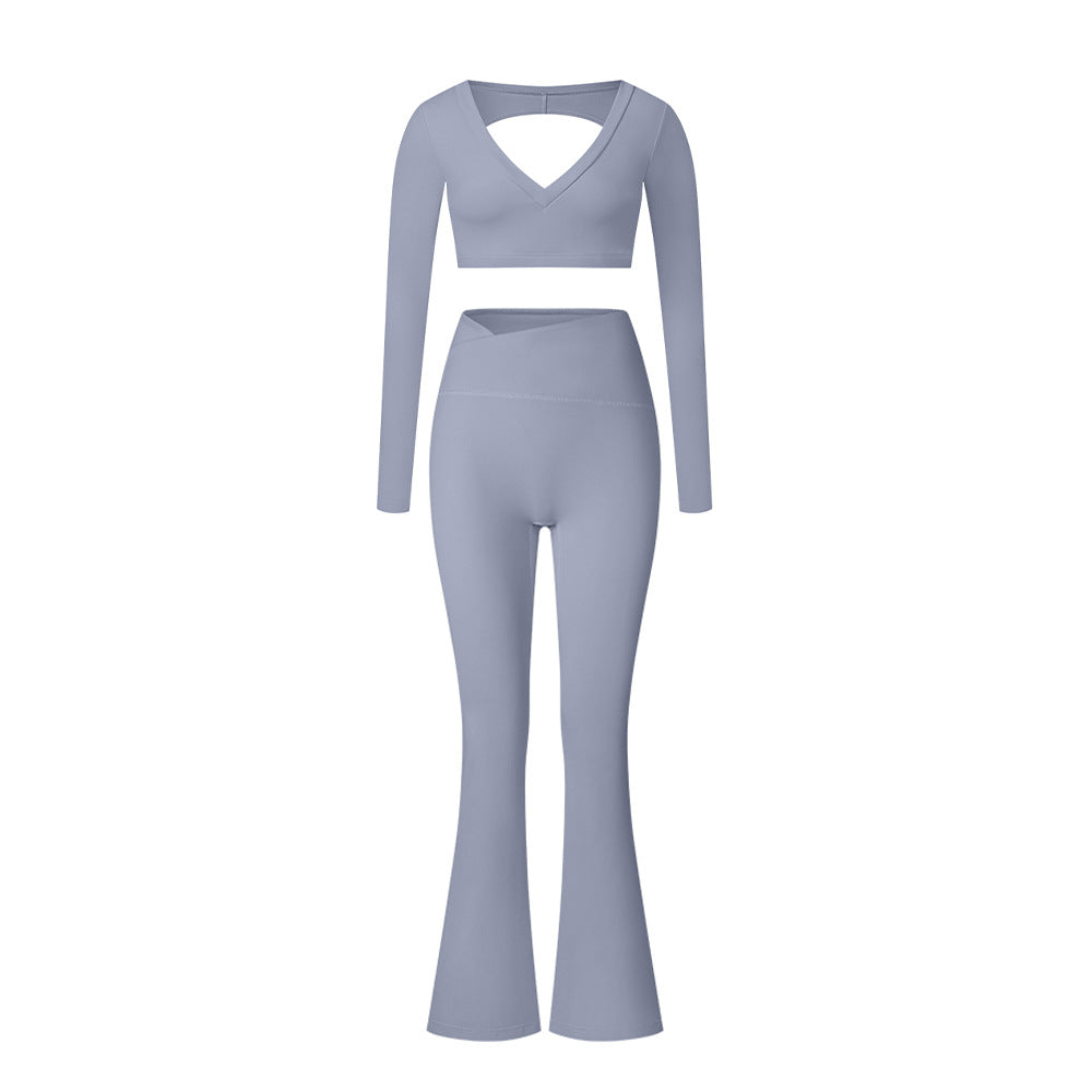 Blue-gray V-neck long sleeve workout set with crop top and flared leg pants on white background