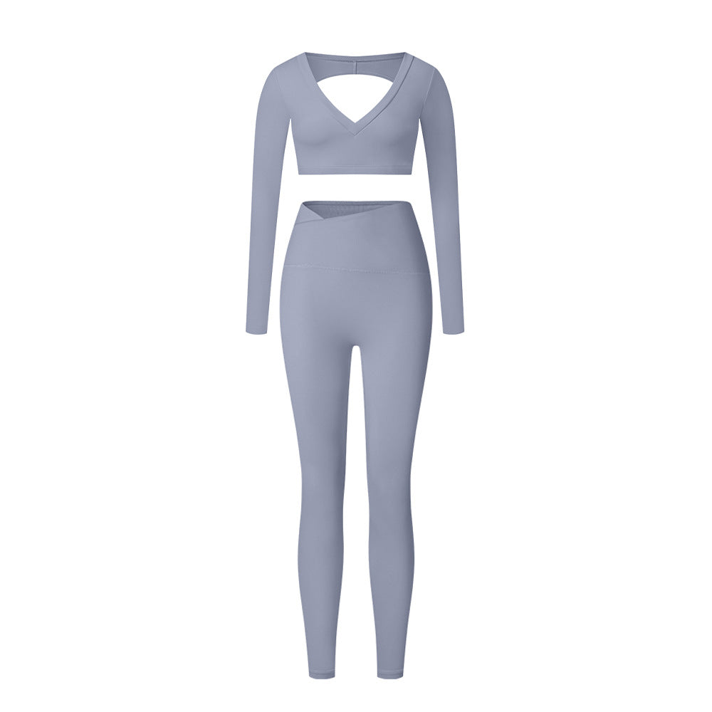 Blue-gray workout set with slim-fit leggings and V-neck long sleeve crop top showing back cutout