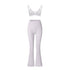 White strappy sports bra with dual shoulder straps and high-waisted flared yoga pants against white background