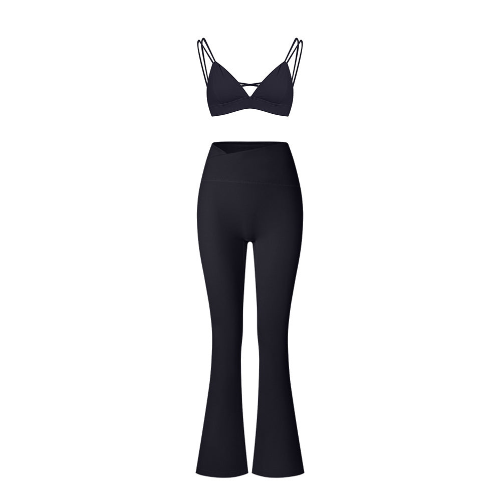 Black strappy workout set with triangle bralette top and high-waisted flared leggings on white background