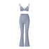 Powder blue strappy sports bra with matching flared yoga pants on white background