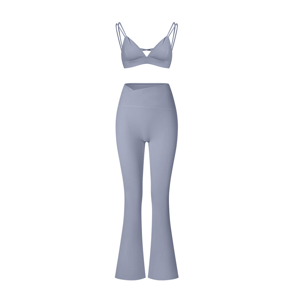 Powder blue strappy sports bra with matching flared yoga pants on white background