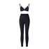 Black strappy triangle bralette and high-waisted leggings set with asymmetrical waistband on white background