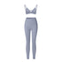 Powder blue strappy triangle bralette and high-waisted leggings set with asymmetrical waistband on white background