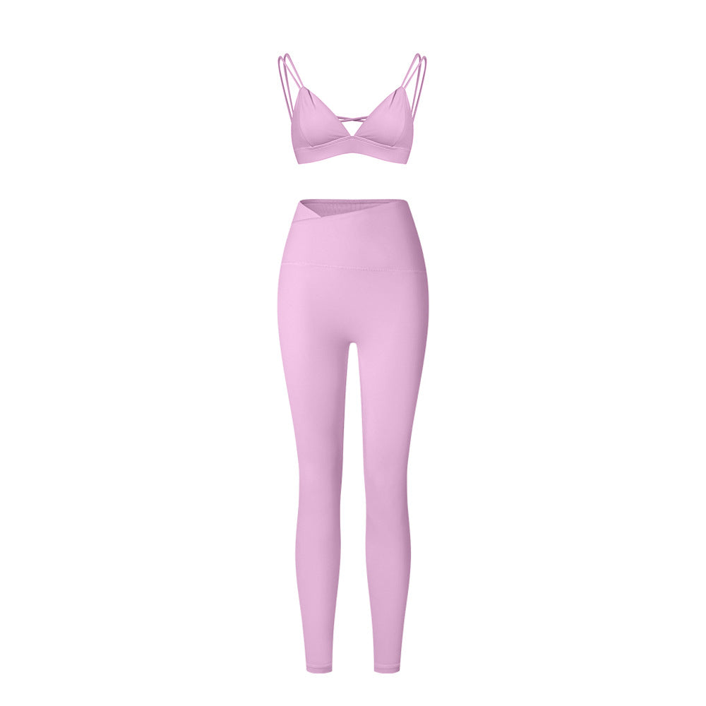 Lilac strappy triangle bralette and high-waisted leggings set with asymmetrical waistband on white background