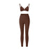 Brown strappy triangle bralette and high-waisted leggings set with asymmetrical waistband on white background