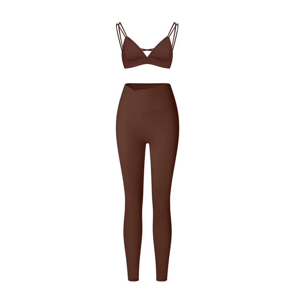 Brown strappy triangle bralette and high-waisted leggings set with asymmetrical waistband on white background