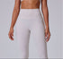 A woman wearing white high-waisted athletic leggings with a wide waistband, shown from the front with hands at sides against a gray background