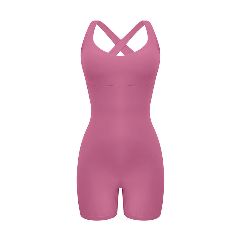 Mauve pink cross-back bodysuit with sweetheart neckline and bike short length displayed against white background