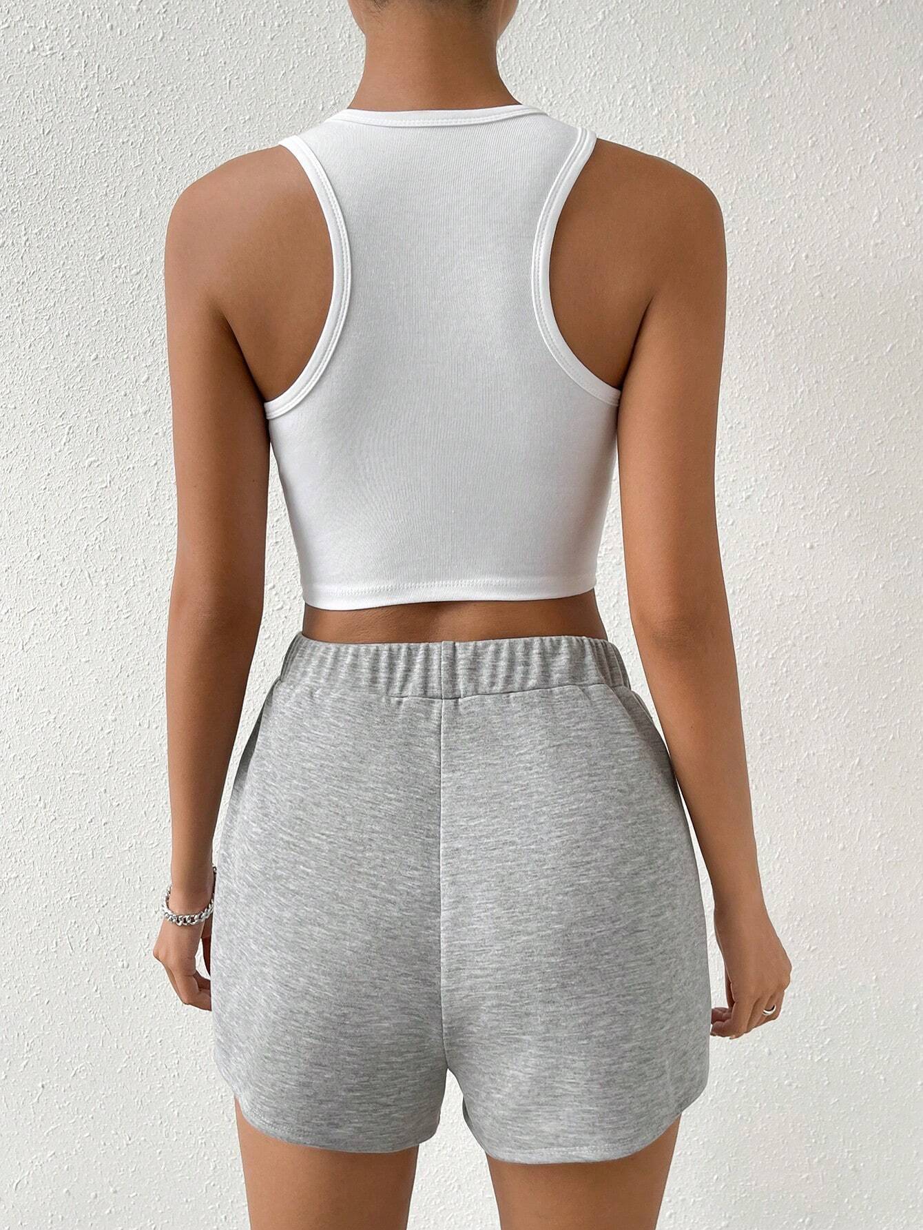 Back view of white racerback crop top and grey jersey skort set