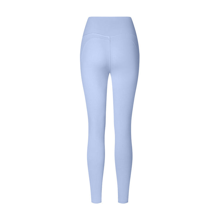 Light blue high-waisted athletic leggings with curved back seams, shown from behind against a white background