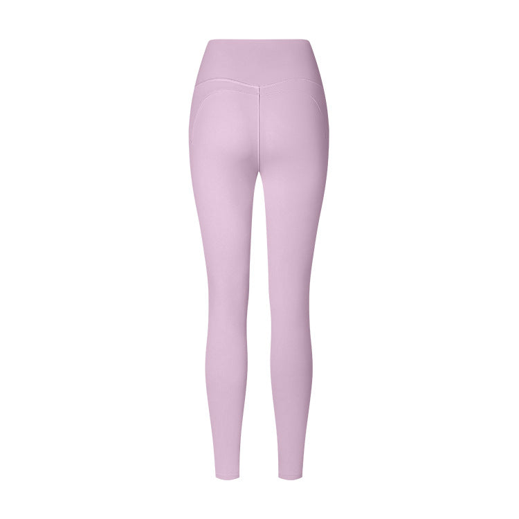 Lavender high-waisted athletic leggings with contoured seams, photographed from behind against a white background