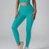 A model wearing teal ribbed leggings with V-waistband and matching crop top against gray background