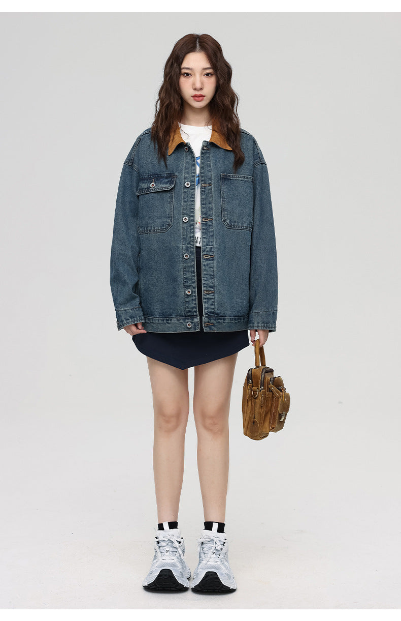 Woman in blue denim jacket with brown corduroy collar over graphic tee and navy skirt with brown handbag