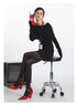 Black off-shoulder sweater with fold-over neckline and fitted sleeves, styled with ID lanyard. Side sitting view.