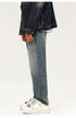 Side view of wide leg faded denim jeans with dark denim jacket and platform sneakers