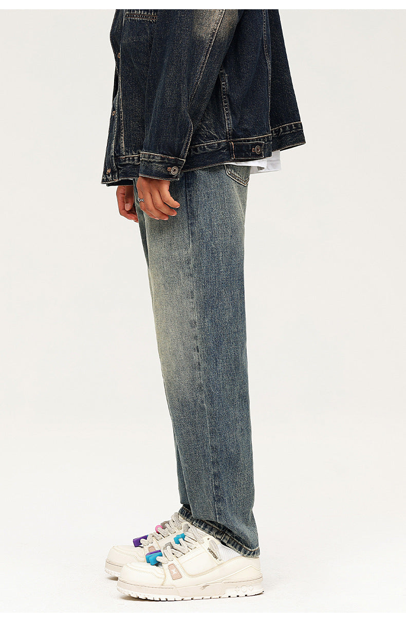 Side view of wide leg faded denim jeans with dark denim jacket and platform sneakers
