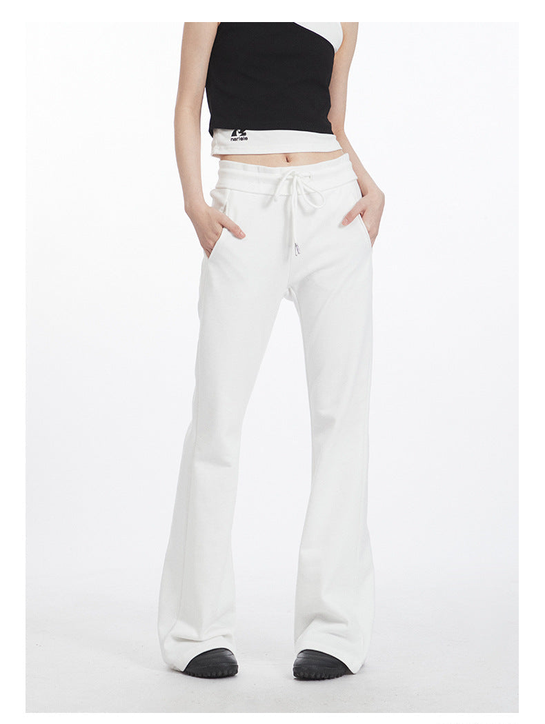 White flared pants with drawstring waist and front pockets, ankle-length view