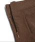 Side zipper detail of the brown pleated skort, showing its hidden closure.