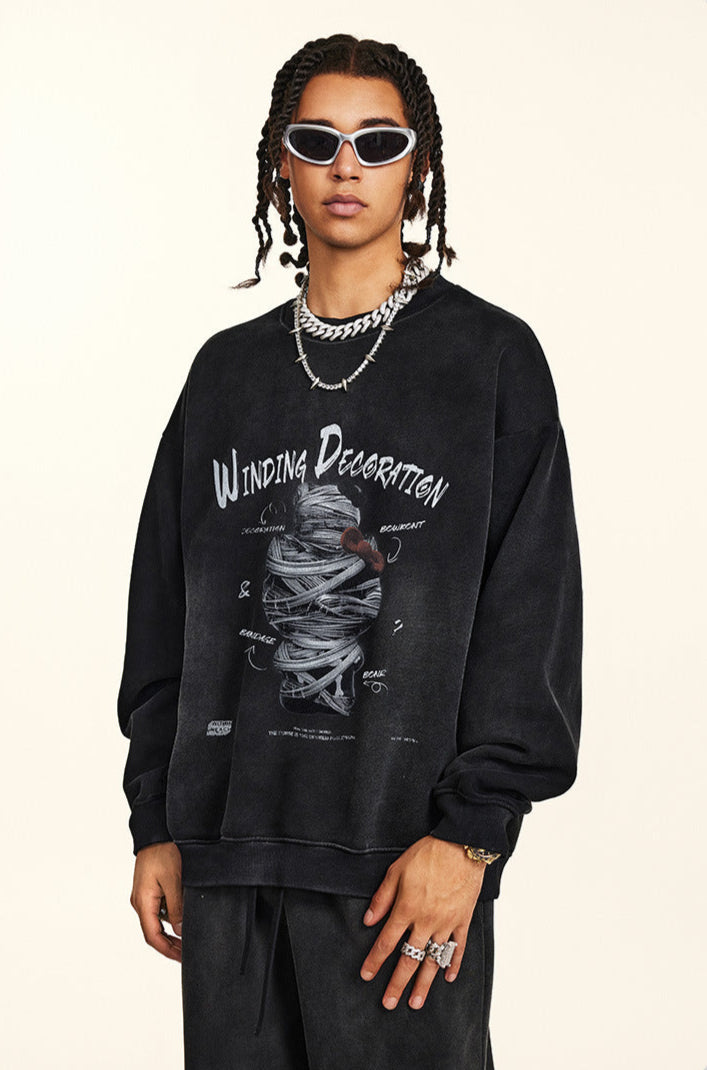 Model wearing black sweatshirt with Winding Decoration graphic print, twisted braided hair, white-framed sunglasses, layered silver chain necklaces, cream background