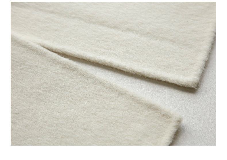 Macro shot showing dense weave structure of cream wool fabric