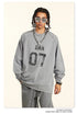 Close-up of gray 'ERA 07' sweatshirt showing distressed logo detail