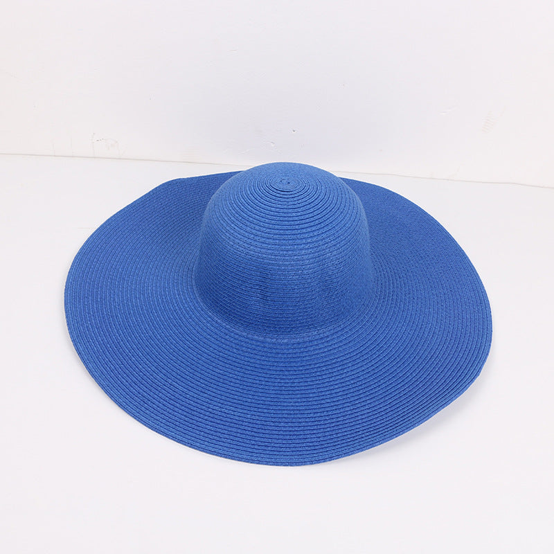 Blue wide-brimmed sun hat with a structured design, laid flat against a white background.