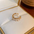 Gold twisted ear cuff with pearl accents displayed in white jewelry box with gold trim