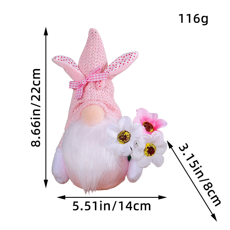 Easter gnome with an 8.66in (22cm) pink knitted hat, white bunny ears, white beard, and fabric flowers.