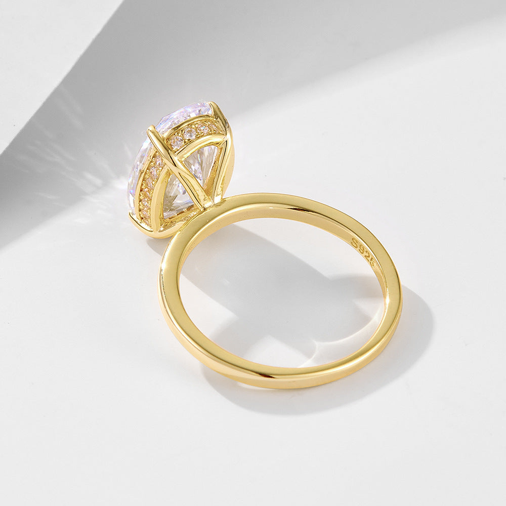Gold engagement ring shown from back view, featuring diamond-accented basket setting with oval center stone and '925' hallmark