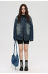 Female model wearing oversized denim jacket, black shorts, and platform boots with denim handbag