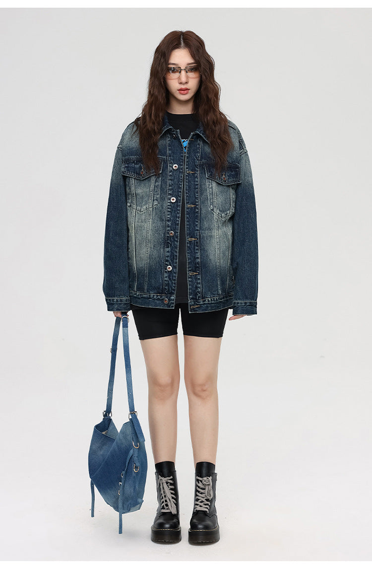 Female model wearing oversized denim jacket, black shorts, and platform boots with denim handbag