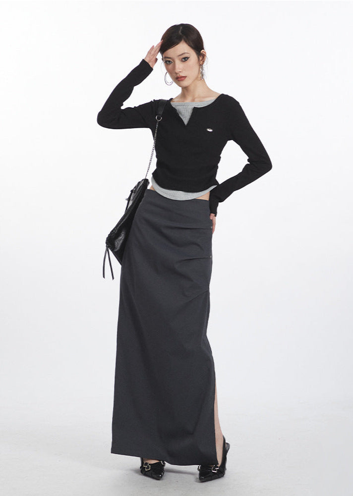 Black and gray layered midi skirt with high side slit, showcasing modern urban fashion styling