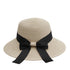Off-white straw sun hat with a black ribbon bow, featuring a wide, floppy brim for elegant sun protection.